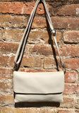 Small leather bag in light beige. Broken white cross body bag in GENUINE leather. Cream color bag with adjustable strap, zipper and flap.