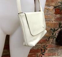 Small leather bag in cream beige. Cross body or shoulder bag in GENUINE leather. Beige leather bag with adjustable strap, zipper and flap.