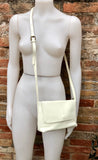 Small leather bag in cream beige. Cross body or shoulder bag in GENUINE leather. Beige leather bag with adjustable strap, zipper and flap.