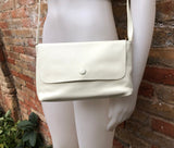 Small leather bag in cream beige. Cross body or shoulder bag in GENUINE leather. Beige leather bag with adjustable strap, zipper and flap.