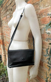 Small leather bag in black. Cross body or shoulder bag in GENUINE leather. Black leather bag with adjustable strap, zipper and flap.