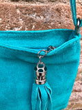 TURQUOISE suede leather bag. GENUINE leather small crossbody / shoulder bag.Adjustable strap and zipper. Turquoise blue purse with tassel.