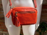 Small orange leather bag. GENUINE leather shoulder or cross body bag. Bright orange leather purse with tassels, adjustable strap and zipper