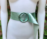 Metallic mint green leather waist belt with large round buckle. Soft leather belt in light aqua green.. Green wide waist belt