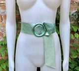 Metallic mint green leather waist belt with large round buckle. Soft leather belt in light aqua green.. Green wide waist belt