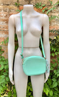 Small leather bag in aqua green. GENUINE leather cross body / shoulder bag. Light turquoise green purse. Tassel on the zipper. Gold accents.