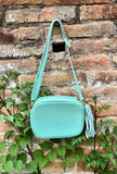 Small leather bag in aqua green. GENUINE leather cross body / shoulder bag. Light turquoise green purse. Tassel on the zipper. Gold accents.