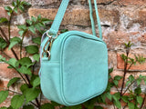 Small leather bag in aqua green. GENUINE leather cross body / shoulder bag. Light turquoise green purse. Tassel on the zipper. Gold accents.