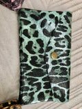 Cheetah print coin purse in genuine metallic leather with 3 pockets, zipper + flap. Fits credit cards, coins, bills. Leopard print wallet.