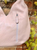 LIGHT PINK genuine leather bag. Pink shoulder bag closed with a zipper. Several pockets.