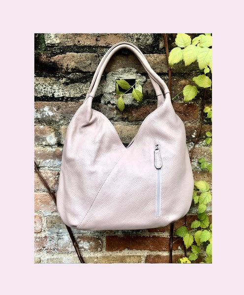 LIGHT PINK genuine leather bag. Pink shoulder bag closed with a zipper. Several pockets.