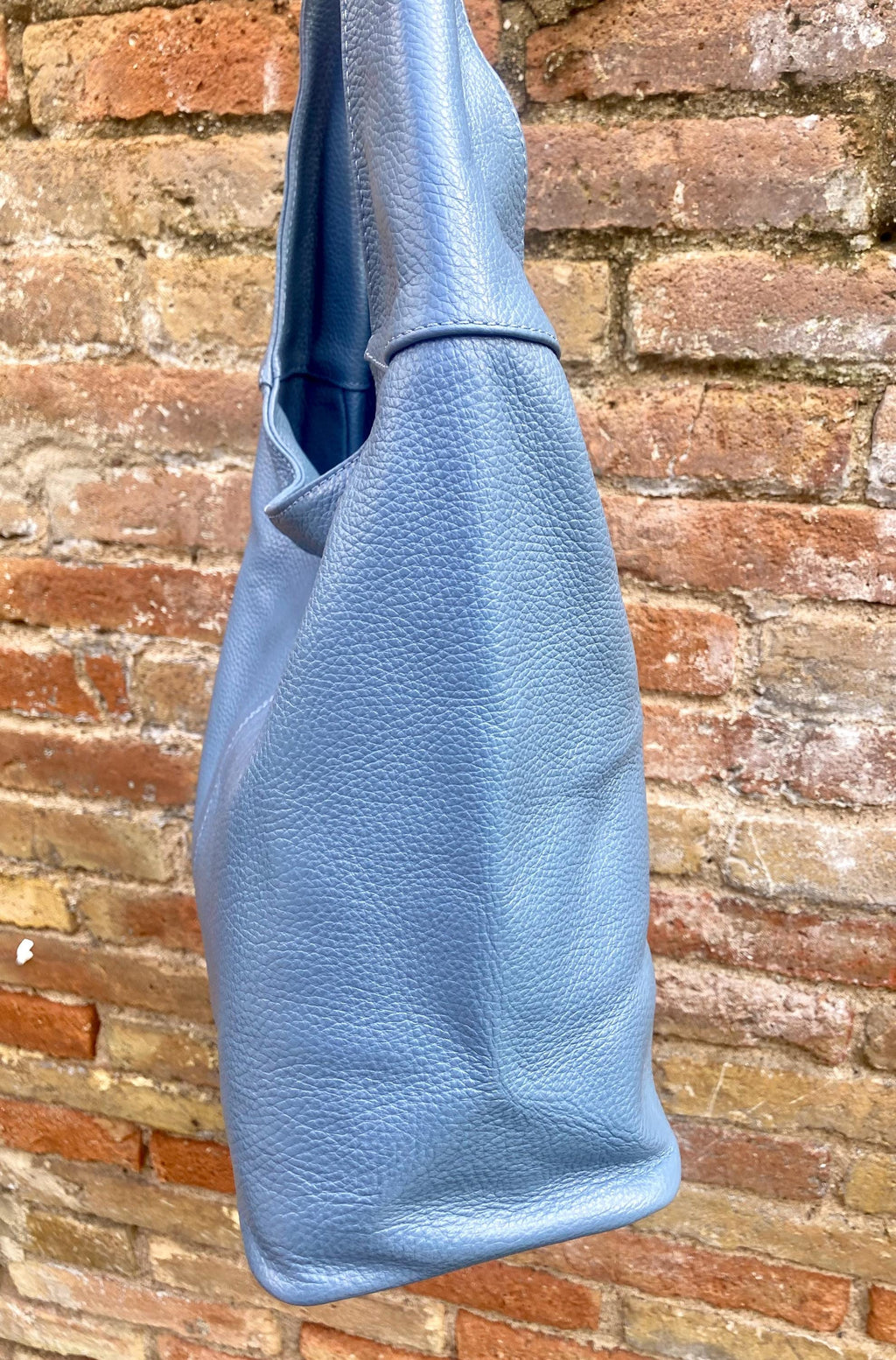 Blue genuine leather shoulder bag. Blue - gray slouchy bag. Wide strap, lined closed with a zipper. Denim blue leather shopper.