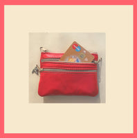 Red coin purse with zippers, genuine leather. Small wallet for credit cards, coins and notes. Soft red leather.