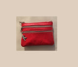 Red coin purse with zippers, genuine leather. Small wallet for credit cards, coins and notes. Soft red leather.